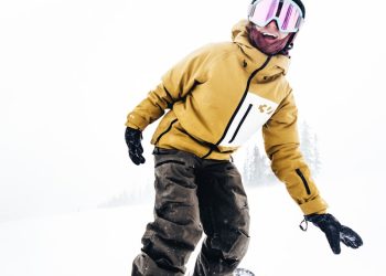 Snowboarder enjoying a snowy day on the slopes.