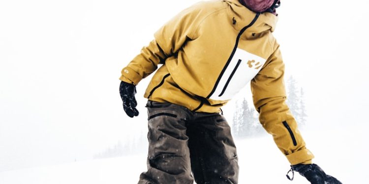 Snowboarder enjoying a snowy day on the slopes.